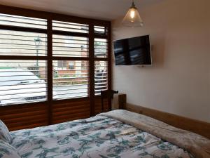 a bedroom with a bed and a flat screen tv at Sparrow - Uk30747 in Acton Trussell