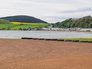 a group of tires sitting next to a body of water at The Dolphin - Uk31004 in Avoch