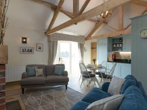 a living room with a couch and a table at Daisy in Scruton