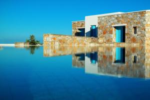 a building sitting on top of a large body of water at Miramare Hotel in Chora Folegandros