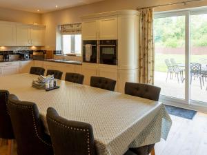 a kitchen and dining room with a table and chairs at Deneville in Heighington