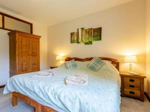 1 dormitorio con 1 cama con toallas en The Milking Shed - Uk30436, en Kingsbury Episcopi