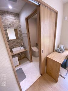 a bathroom with a toilet and a sink at 山の源-Yama No Minamoto in Furano