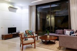 a living room with a couch and a table at StayVista at Bella Orion with Pvt Pool- North Goa in Calangute