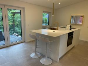 a kitchen with a island in the middle of a room at The View in Ensch