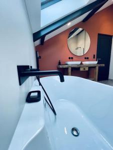 a bathroom with a white sink and a mirror at Villa Metz / Amnéville 200m2 in Vigy