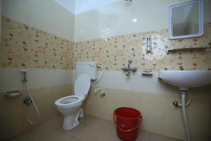 a bathroom with a toilet and a sink at Railview inn Bhubaneswar in Bhubaneshwar