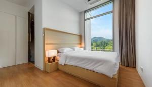 a bedroom with a large bed with a large window at Bayclub in Namhae