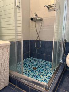 a bathroom with a shower with a glass shower stall at G&S Beach House in Flogita
