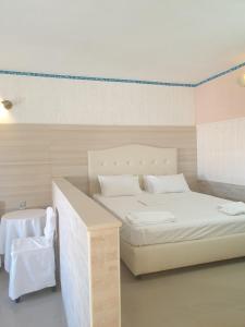 a room with two beds and a table at Private Studio Korifi sea view in Hersonissos