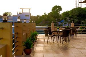 a patio with a table and chairs on a balcony at Dianna’s Inn in Coron