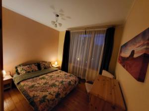 a small bedroom with a bed and a window at 19 Jasminu street in Jūrmala