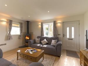 a living room with a couch and a coffee table at The Old Kennels in Tibberton