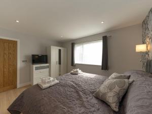 a bedroom with a large bed with two towels on it at The Old Kennels in Tibberton