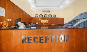 a reception desk in an office with a reception counter at Treebo Trend MP Inn in Raipur