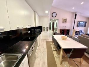 a kitchen with a table and a dining room at Canillo Novell C HUT - 6714 in Canillo