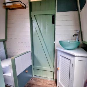 a bathroom with a sink and a toilet at Mini Escape - 2 Berth Narrowboat on the Grand Union, Hertfordshire 