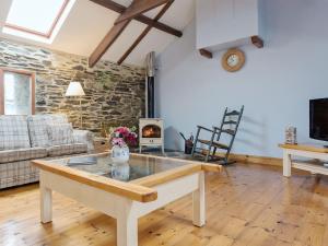 a living room with a table and a fireplace at New England-uk12750 in Menheniot