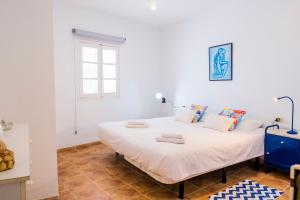 Postel nebo postele na pokoji v ubytování Live Puertito Casa Azul