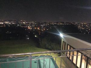 a view of a city at night from a balcony at Views for Africa in Johannesburg