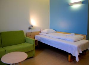 En eller flere senger på et rom på Hotel St. Olav