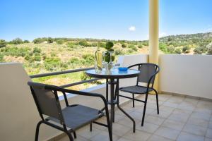 a table and two chairs on a balcony with a view at Villa Stefania Dream in Érfoi