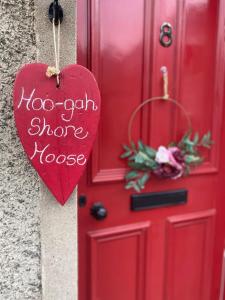 a red door with a heart that says too gun morenox at Stunning Apartment in Newburgh Scotland sleeps 4 in Cupar