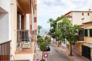 a street in a town with buildings and trees at Apt RIERES in Port de Pollensa