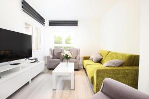a living room with a yellow couch and a tv at Apt RIERES in Port de Pollensa