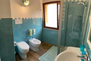 a bathroom with a toilet and a sink and a shower at B&B da Miranna in Dorgali