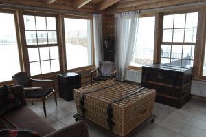 ein Wohnzimmer mit Möbeln und Fenstern in der Unterkunft Chalet de Charme, Cedars, Lebanon, Balcony Floor in Al Arz