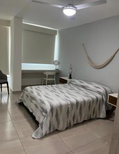 a bedroom with a bed and a table and a ceiling at Beautiful Apartment fully equipped AC 6 people 3 Bedrooms Wifi in Manzanillo +22 photos