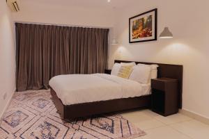 a bedroom with a bed and a large window at The Avery, 2 Bed Duplex Apartment at Embassy Gardens in Accra +23 photos
