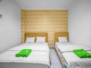 Posteľ alebo postele v izbe v ubytovaní Hotel Cempaka Sari