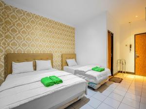 Posteľ alebo postele v izbe v ubytovaní Hotel Cempaka Sari