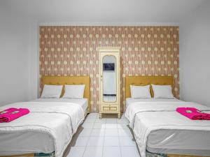 Posteľ alebo postele v izbe v ubytovaní Hotel Cempaka Sari