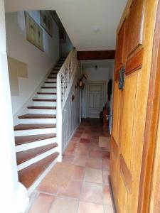 a hallway with a stairway with a white stair case at Os-Auszeit in Oberschwarzach