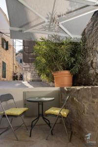 um pátio com uma mesa, cadeiras e plantas em Residence Marina em Split