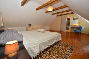 a bedroom with a bed and a desk and a chair at Green silence in Bedenica