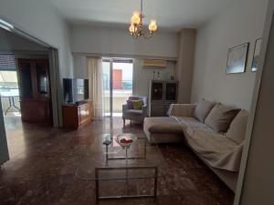a living room with a couch and a table at Apartment 110 sqm free parking in Patra