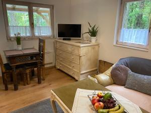 uma sala de estar com uma mesa com uma taça de fruta em Mesebeli Vendégház em Kismaros