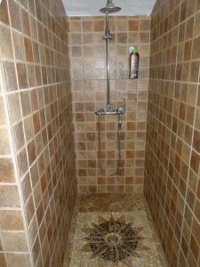 a shower with a drain in a tiled bathroom at Holiday Home El Brezal in El Palmital