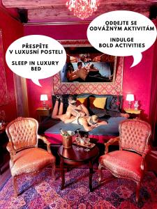 un poster di una camera da letto con 2 donne sdraiate su un letto di OROOM St Petersburg - Role Play For Couples in BRNO a Brno