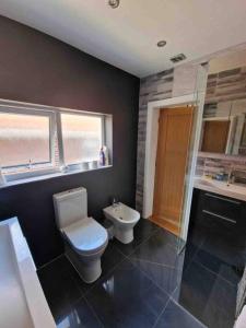 a bathroom with a toilet and a sink at Lovely studio annex in Lilliput in Poole