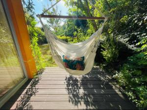 a hammock hanging on a porch with a window at 70m2 Romantic Living in the Old Town with Garden in Bratislava