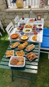 a table filled with different types of food on it at Grand Alaçatı Butik Hotel in Alaçatı