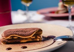 a sandwich sitting on a plate on a table at Hotel Indigo Milan - Corso Monforte, an IHG Hotel in Milan