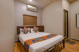a bedroom with a large bed in a room at FabExpress Comfort Stay in Mumbai