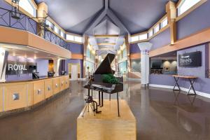 a room with a piano in the middle of a building at Royal Hotel Edmonton Airport Trademark Collection By Wyndham in Leduc