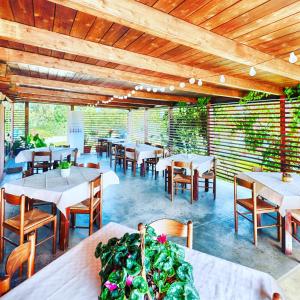 a dining room with tables and chairs and wooden ceilings at Agriturismo Il Paradiso in Iglesias